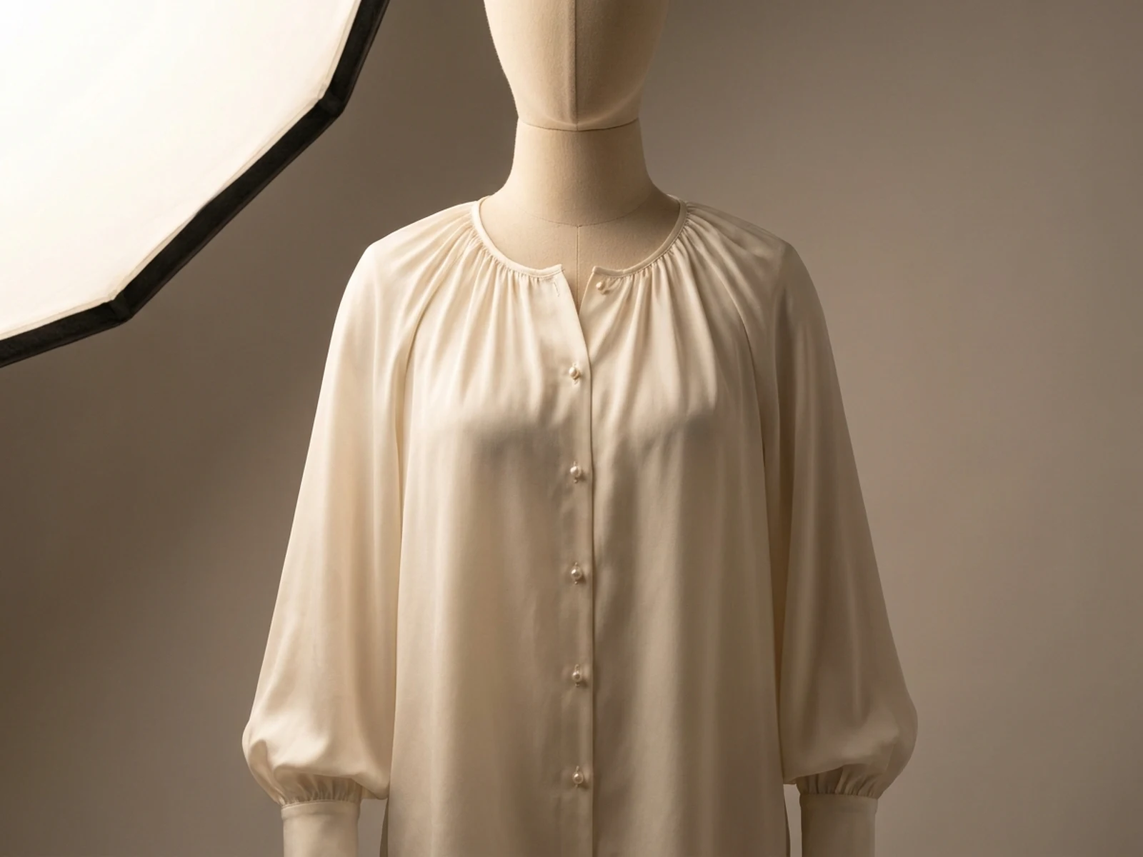 Original ivory silk blouse with gathered neckline on a neutral mannequin