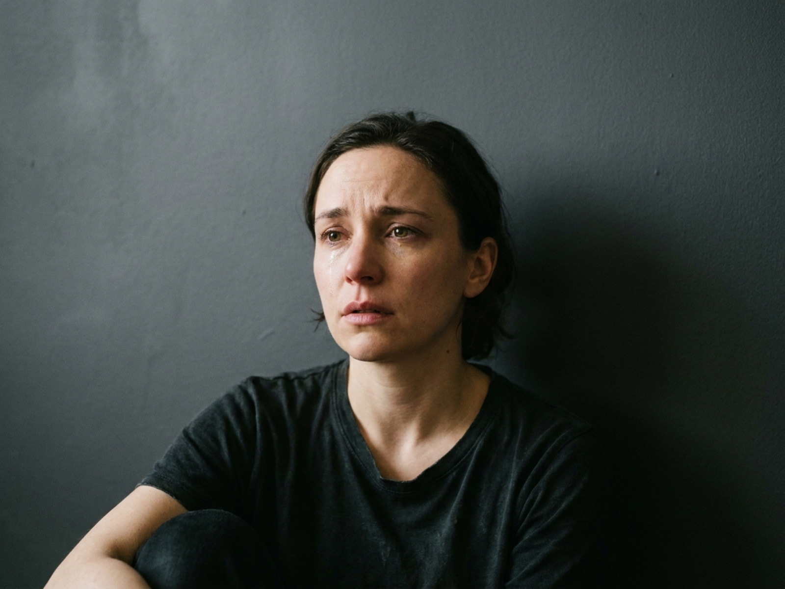 Controlled fictional crying expression study with cinematic portrait lighting