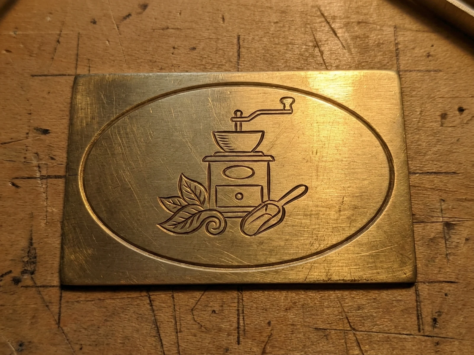 Original coffee tool emblem engraved on a brass sample plate