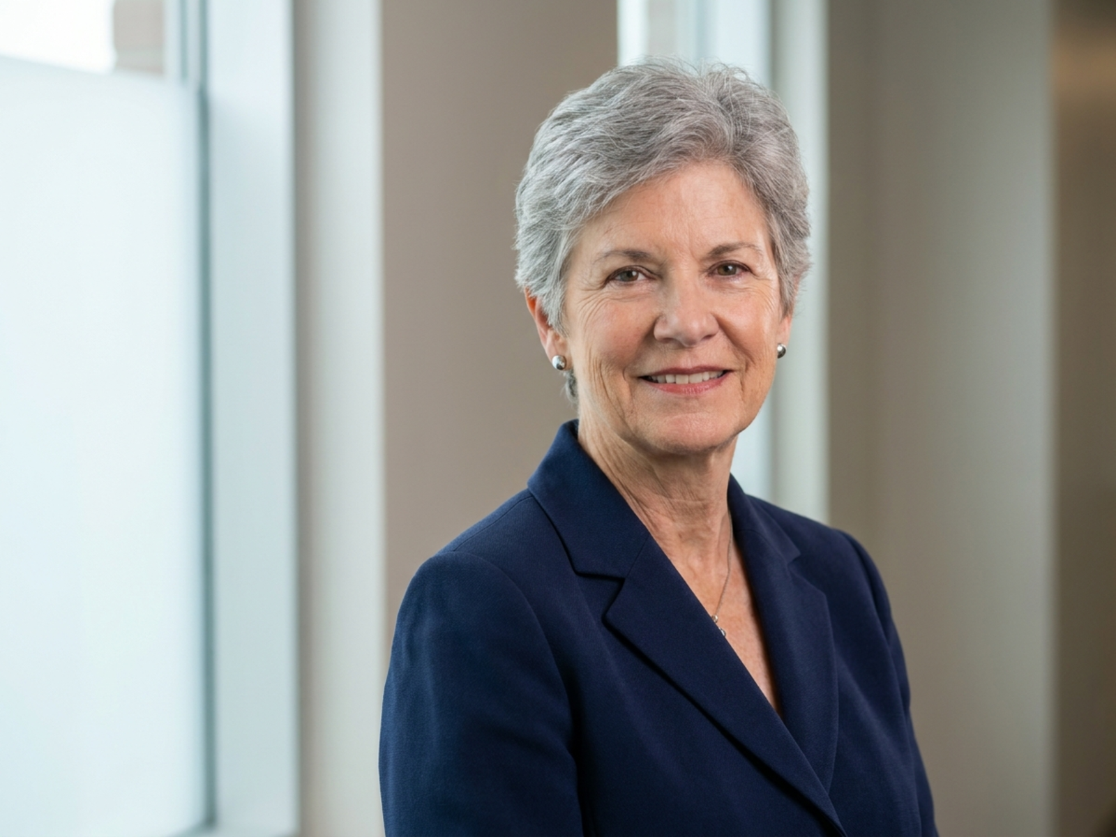Professional headshot of an older woman renewable-energy consultant with natural skin texture
