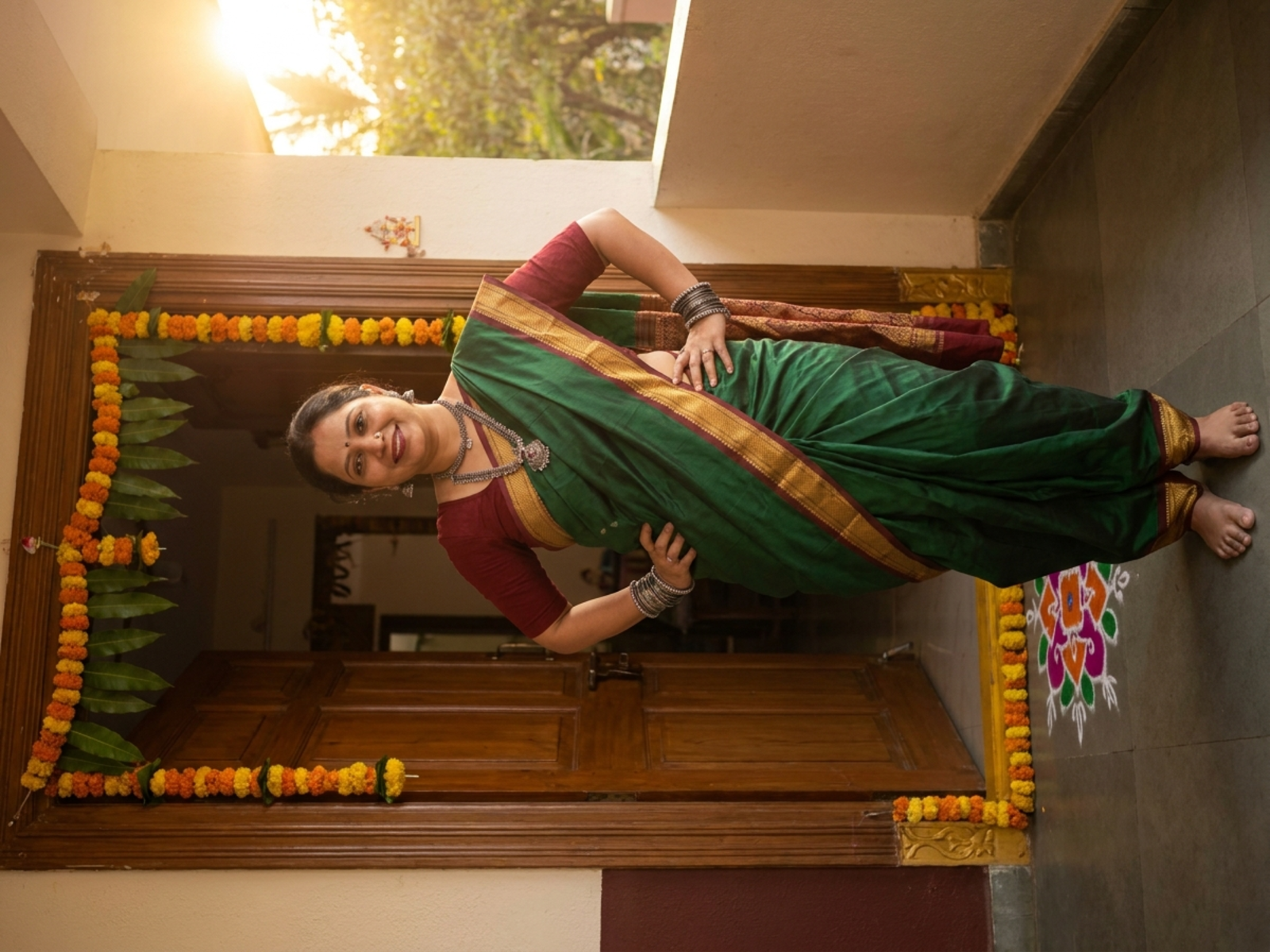 Green silk Nauvari saree styled for a home celebration