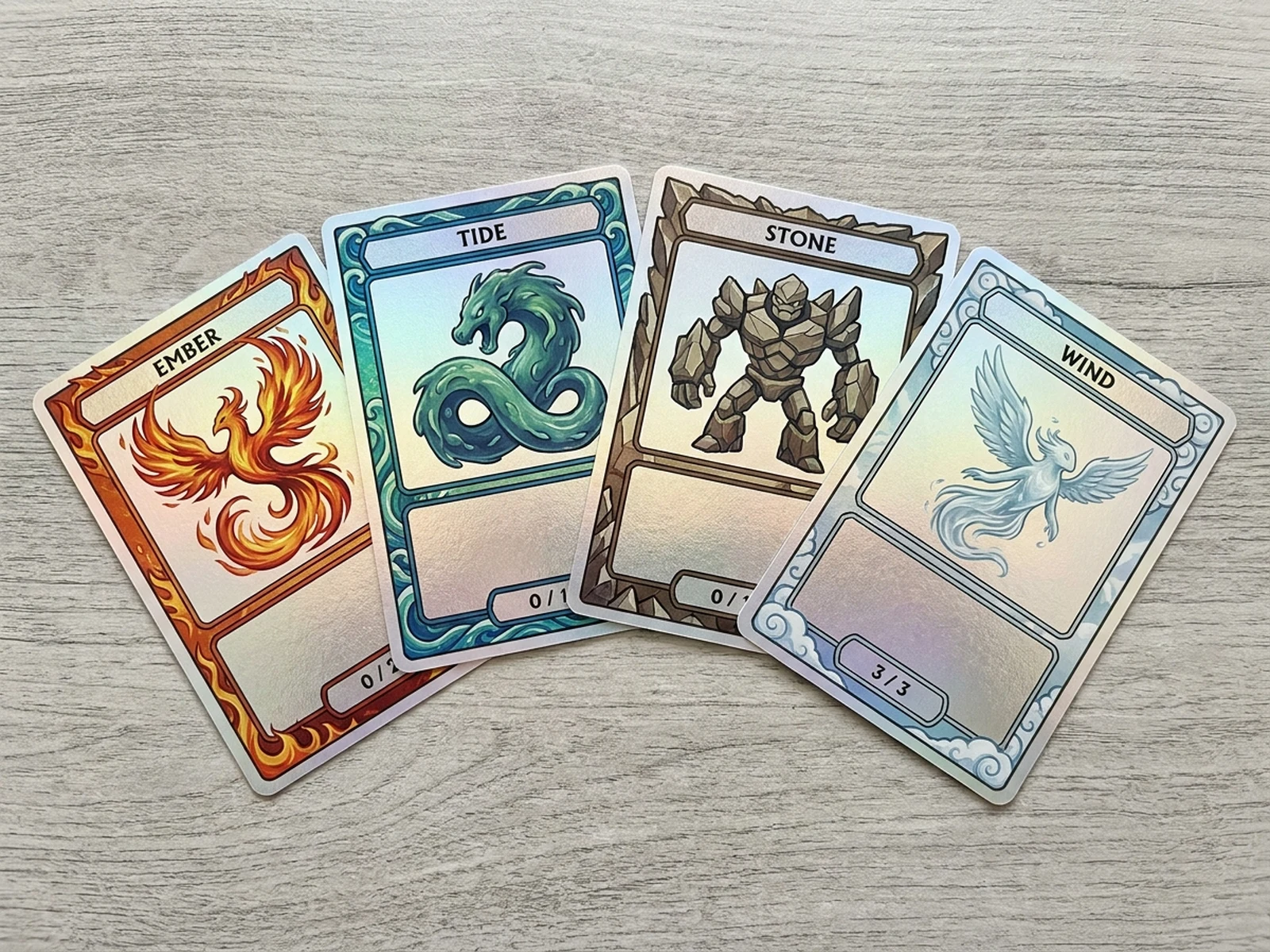 Four original elemental trading cards arranged as a coordinated set