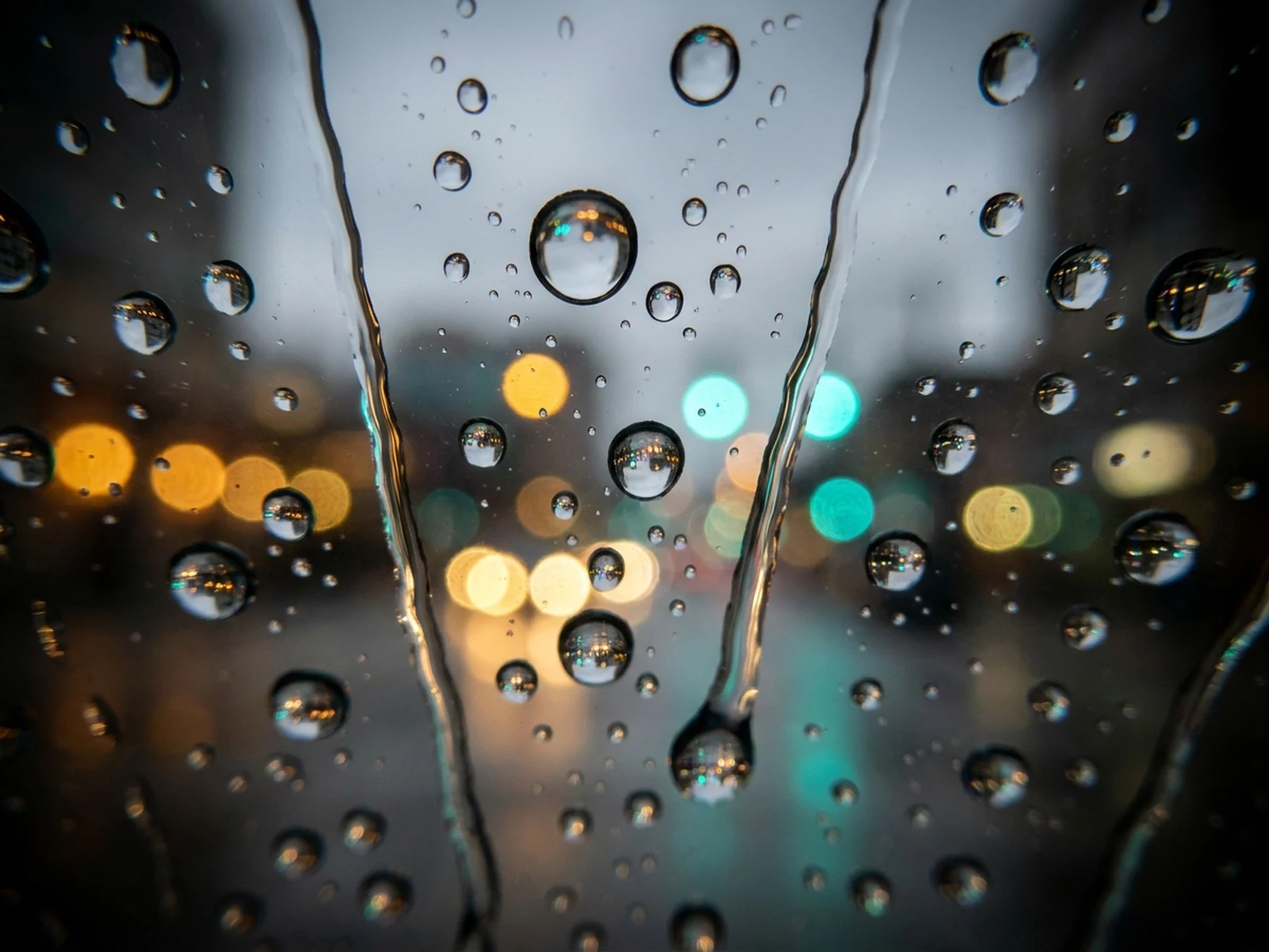 带青橙城市散景与倒影的玻璃窗细致雨滴特写
